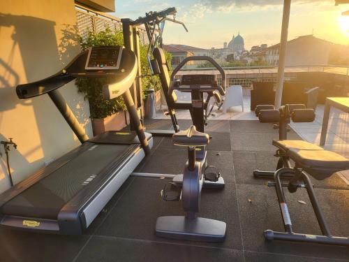 a gym with cardio equipment on the roof of a building at MyForte Relais de Charme & SPA in Florence