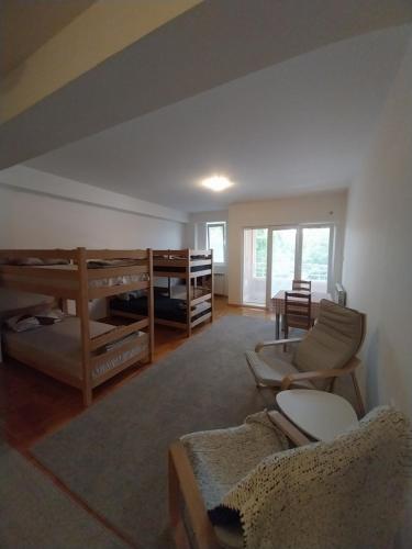 a living room with two bunk beds and a couch at Spacious Hostel Rooms in Skopje
