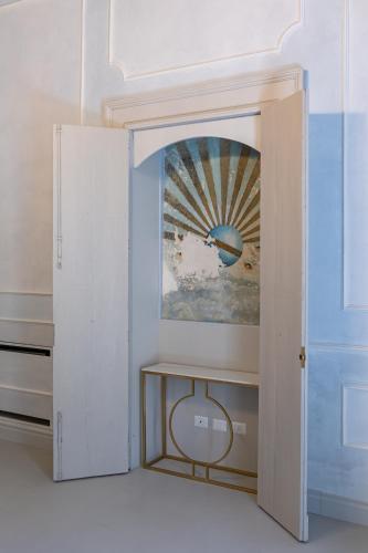 a door into a room with a painting on the wall at Palazzo Zimara Boutique Hotel in Lecce
