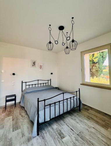 a bedroom with a bed and chandeliers at Bellavista La Querce in Foiano della Chiana