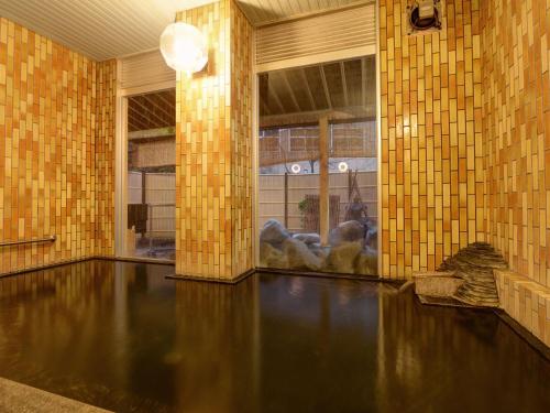 una habitación con un charco de agua en un edificio en 蓬平温泉 蓬莱館 福引屋, en Nagaoka