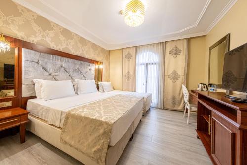 Postel nebo postele na pokoji v ubytování Myy Boutique Hotel