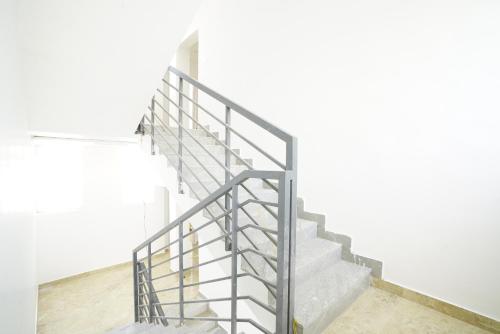 a set of stairs with a metal railing at Quilon Residency Kundara in Perumanseri
