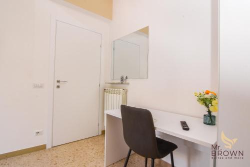 a white kitchen with a desk and a chair at MrBrown - Pincherle Room in Rome