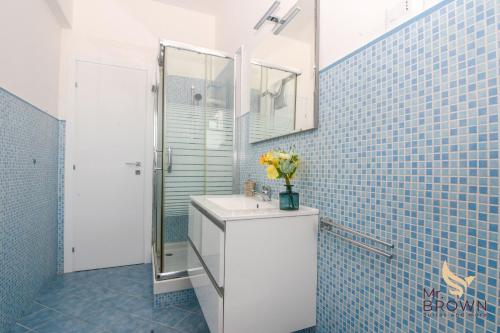 a bathroom with a toilet and a sink with flowers on it at MrBrown - Pincherle Room in Rome