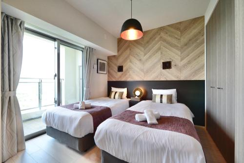 Ένα ή περισσότερα κρεβάτια σε δωμάτιο στο Branchera Naha Akebono Premist R69