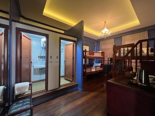 a living room with a staircase and a crib at Casa Der See Boutique House in Songkhla
