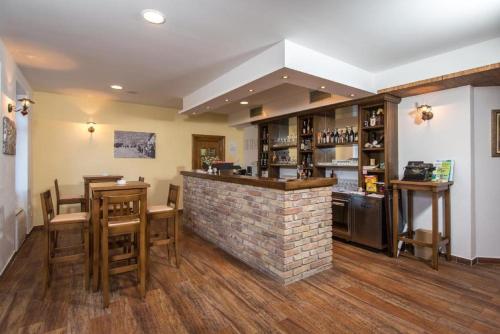 a bar in a restaurant with a brick wall at Apartments Zavala in Ravno
