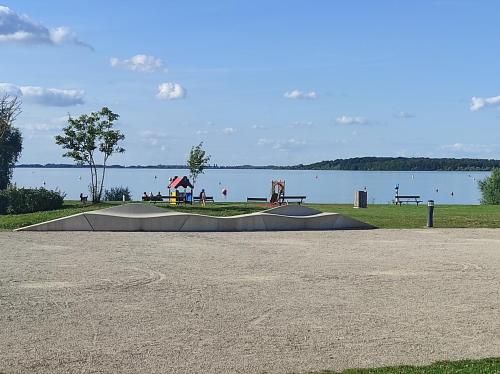 a skateboard ramp in a park next to a lake at Chez CHARLETTE in Les Malots