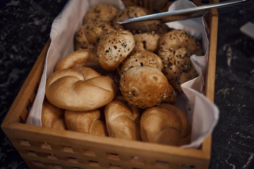 a basket filled with lots of different types of bread at Kapellerhof in Stadl-Paura