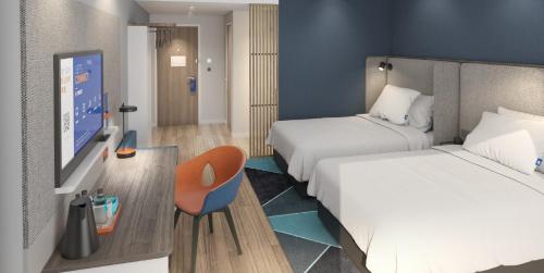 a hotel room with two beds and a flat screen tv at Holiday Inn Express Suzhou East Taihu by IHG in Suzhou