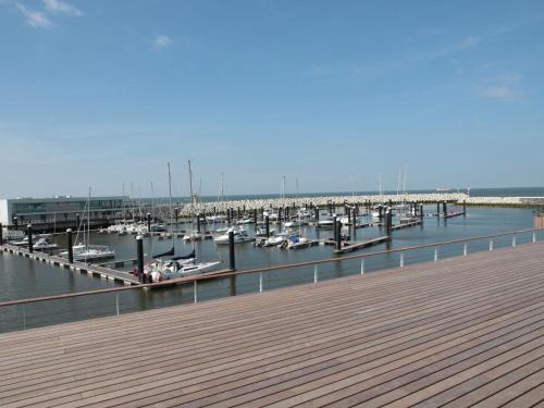 a dock with boats docked in the water at Villa in Zealand near Dutch Flanders Coast in Zuidzande