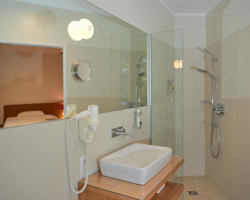 a bathroom with a sink and a shower at Kapellerhof in Stadl-Paura