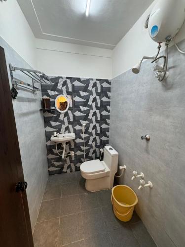 a bathroom with a toilet and a sink at David Residency in Madurai
