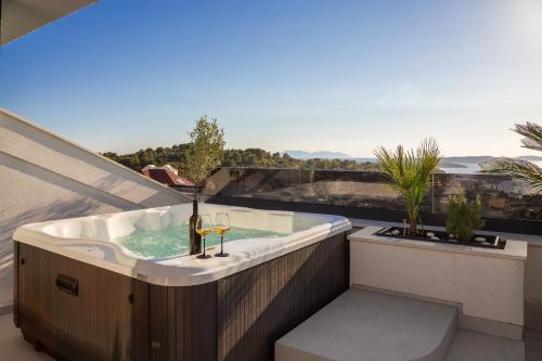 a jacuzzi tub on a balcony with a view at Luxury Penthouse Hvar with Jacuzzi & Sea View in Hvar