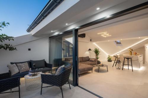 an open living room with sliding glass doors at Luxury Penthouse Hvar with Jacuzzi & Sea View in Hvar