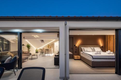 a bedroom with a bed and a living room at Luxury Penthouse Hvar with Jacuzzi & Sea View in Hvar