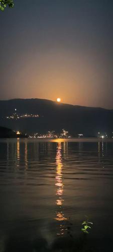 a sunset over a body of water with the sun setting at Ogi Beach Apartment in Orman