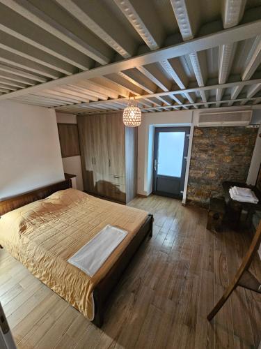a bedroom with a large bed in a room at Danai Traditional Apartment in Samos