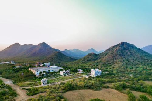 an aerial view of a resort in the mountains at SaffronStays Villa Rohi in Udaipur