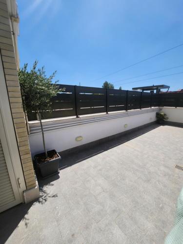 a balcony with a fence and a potted tree on it at House 421 in Rome