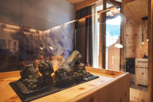 a fireplace in a room with a fire at Hotel Cristallo in Andalo