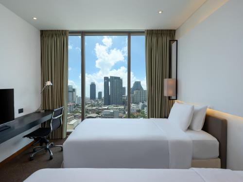Voodi või voodid majutusasutuse Amara Bangkok Hotel toas