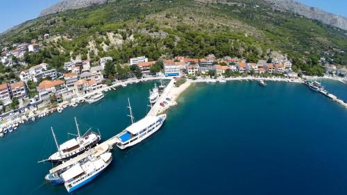 an aerial view of a marina with boats in the water at Hotel Krilo in Podstrana