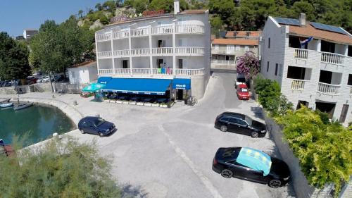 an aerial view of a building with cars parked in a parking lot at Hotel Krilo in Podstrana