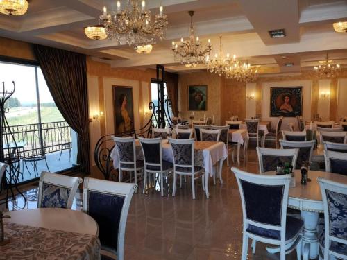 a dining room with tables and chairs and chandeliers at Zlatibor Hills, Top 41 in Zlatibor