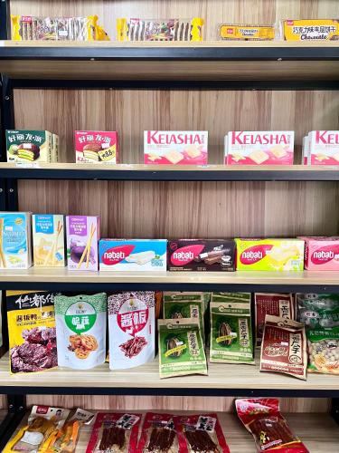 a store shelf filled with different types of food at Zhangjiajie Cliff Flower RV Tent Hotel in Sanguansi