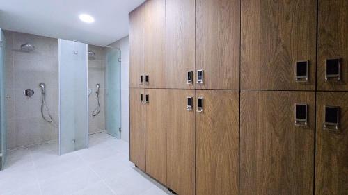 a large bathroom with wooden cabinets and a shower at Black Diamond Hotel Dhermi in Dhërmi