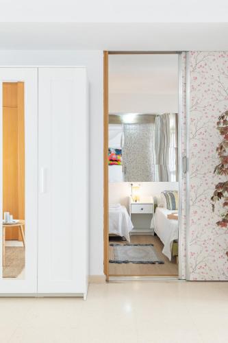 a bedroom with a mirror and a bed at Penthouse Duplex in a 4 floors spanish house -8 min to center by Metro in Valencia