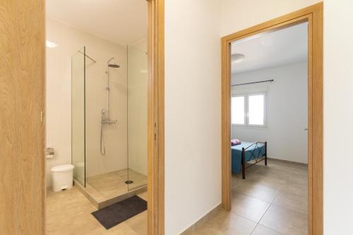 a bathroom with a shower and a glass door at Countryside apartments ground floor in Gómfoi