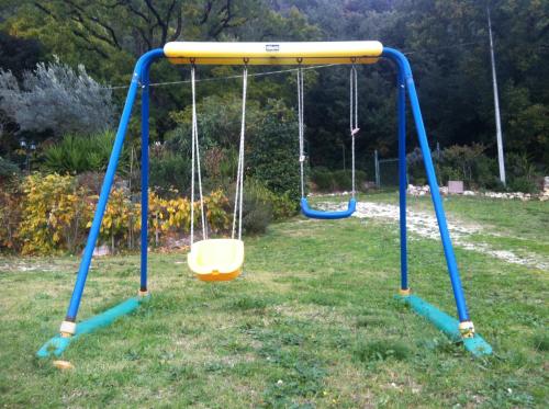 an empty swing set in a yard at B&b La Casa Del Sole in Borgaria