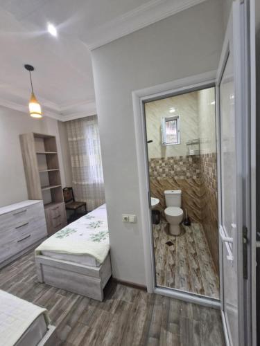 a bedroom with a bathroom with a shower and a toilet at Green paradise in Batumi