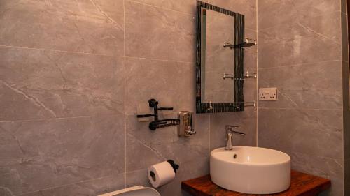 a bathroom with a sink and a toilet at A Villa Sunshine house Zanzibar in Jambiani
