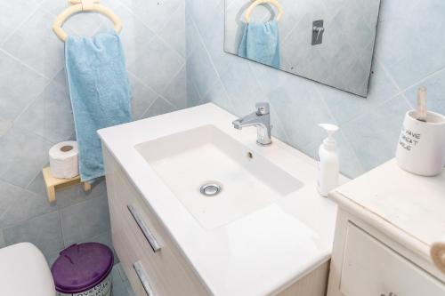 a bathroom with a white sink and a mirror at Casa Andrea in Marina di Ragusa