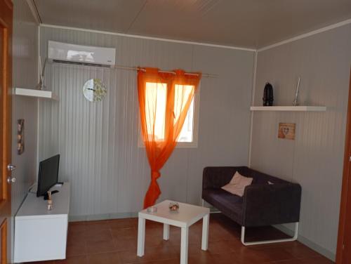 a living room with a couch and a table at Oasi Relax in Rodi Garganico