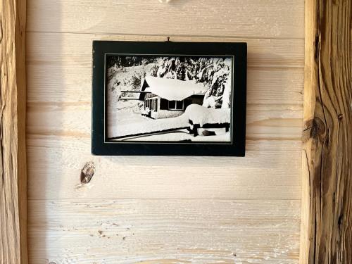 a picture of a house hanging on a wall at Siebenschläferhütte in Buchenberg