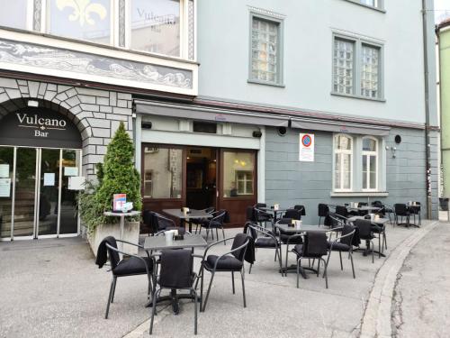 a group of tables and chairs in front of a building at Hotel Surselva in Chur
