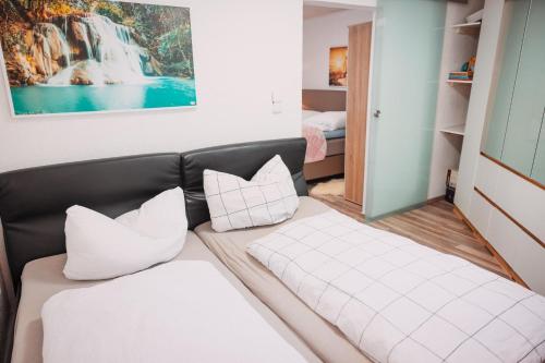 a living room with a couch and two pillows at Bungalow Donaublick mit Pool und Garten in Sankt Nikola an der Donau