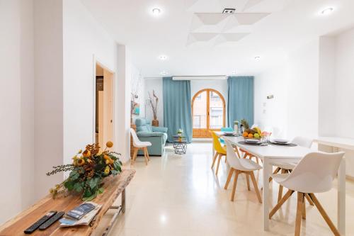a kitchen and living room with a table and chairs at Grand Villa Valencia- large groups-8 min to Center by Metro in Valencia