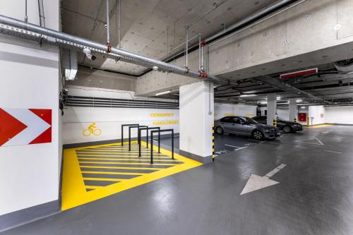 a parking garage with a parking lot with parked cars at Hotel Vision Budapest by Continental Group in Budapest