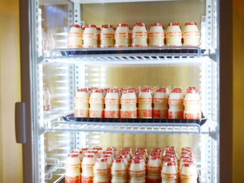 an open refrigerator filled with bottles of soda at Onyado Nono Toyama Natural Hot Spring in Toyama