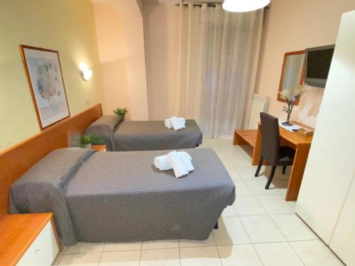 a hotel room with two beds and a desk at Bella Vista B&B in Gissi