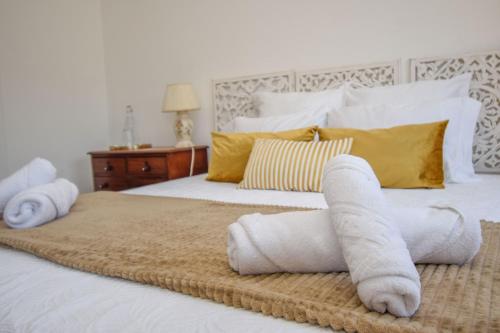 a bedroom with a bed with towels on it at White Star Estoril in Estoril