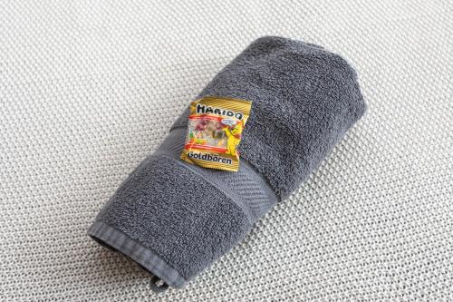 a gray pillow with a pack of gum on it at FullHouse - Magdeburg - L10 Apartments in Magdeburg