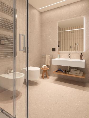 a bathroom with a tub and a sink and a mirror at Naturae Lodge Wellness & Spa in Alleghe
