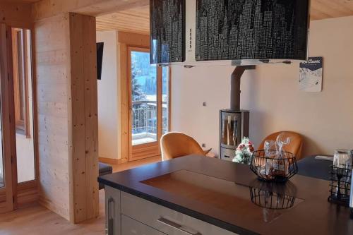 - une cuisine avec un comptoir et des chaises dans la chambre dans l'établissement Appartement Centre ville la Clusaz, à La Clusaz